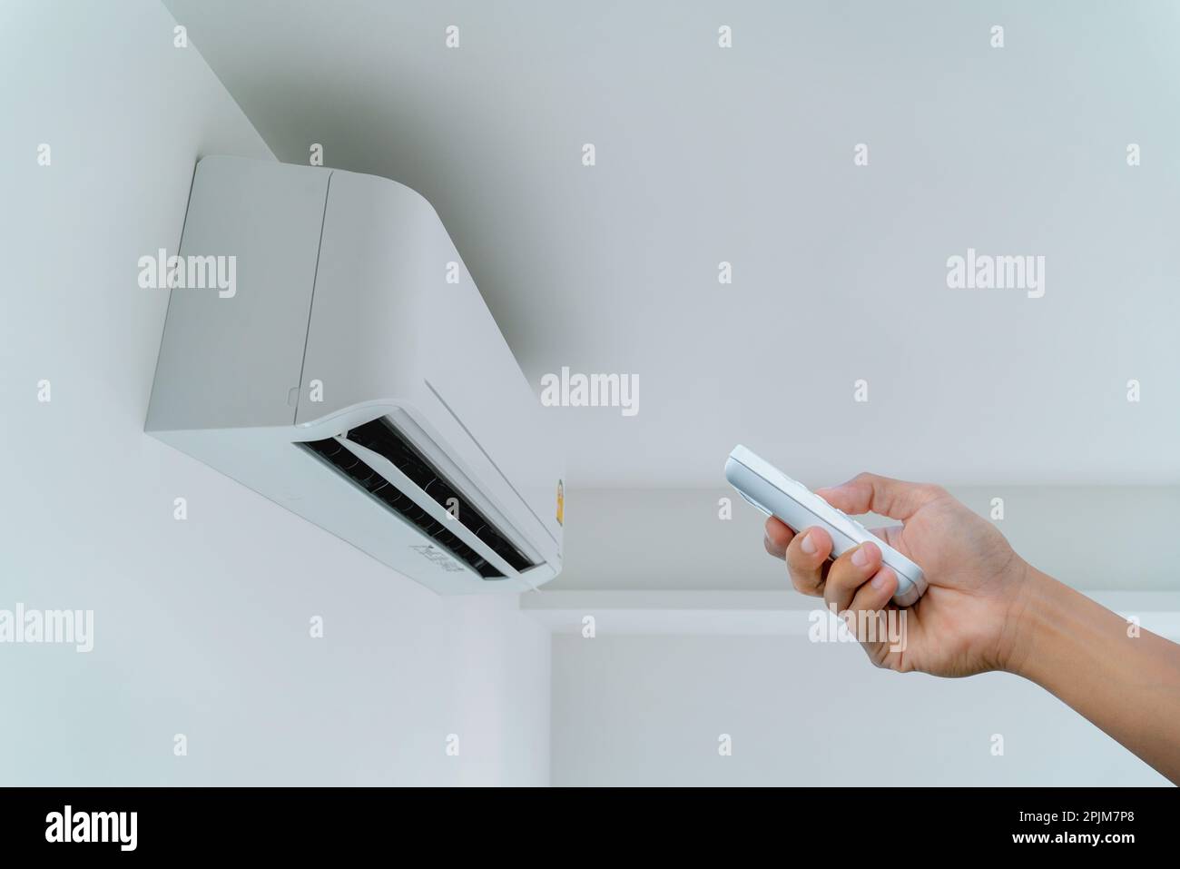 Man turning on the air conditioner Stock Photo Alamy