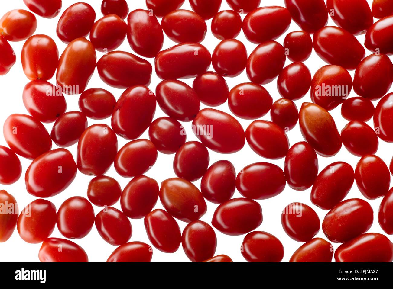 Scattered red cherry tomatoes as background, datterino tomato, top view isolated on white with clipping path included Stock Photo