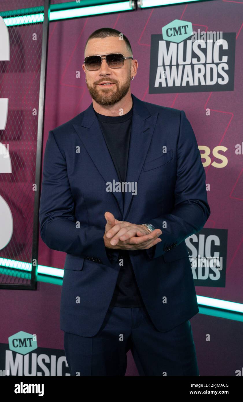 Travis Kelce Soars in Heeled Boots & Navy Suit at CMT Awards 2023 –  Footwear News