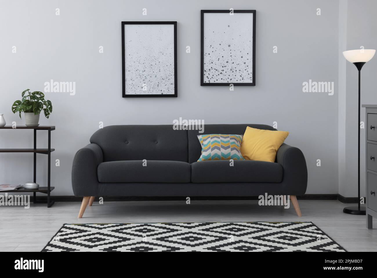 Beautiful living room interior with stylish grey sofa Stock Photo - Alamy