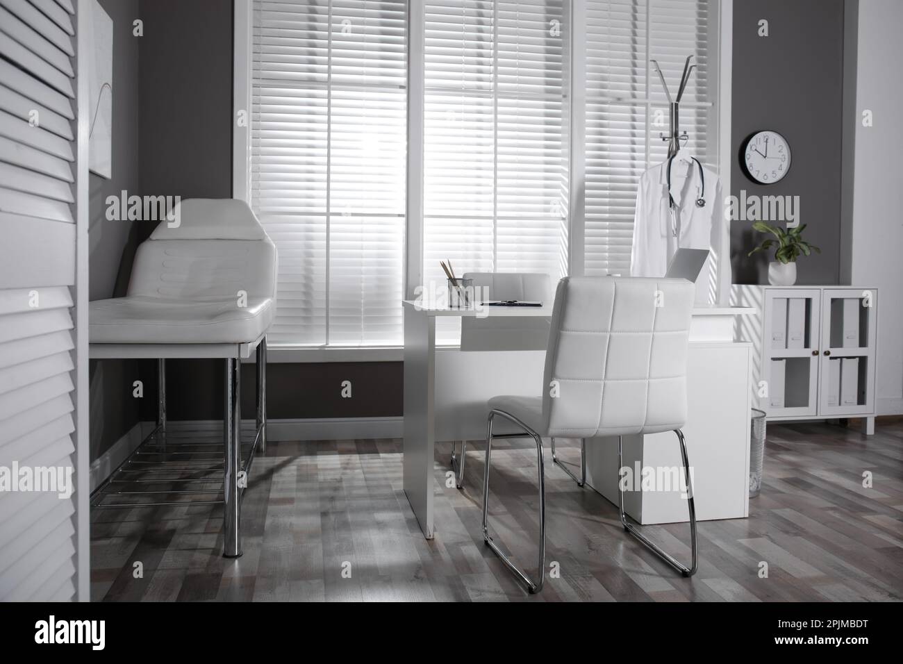 Modern medical office interior with doctor's workplace and examination