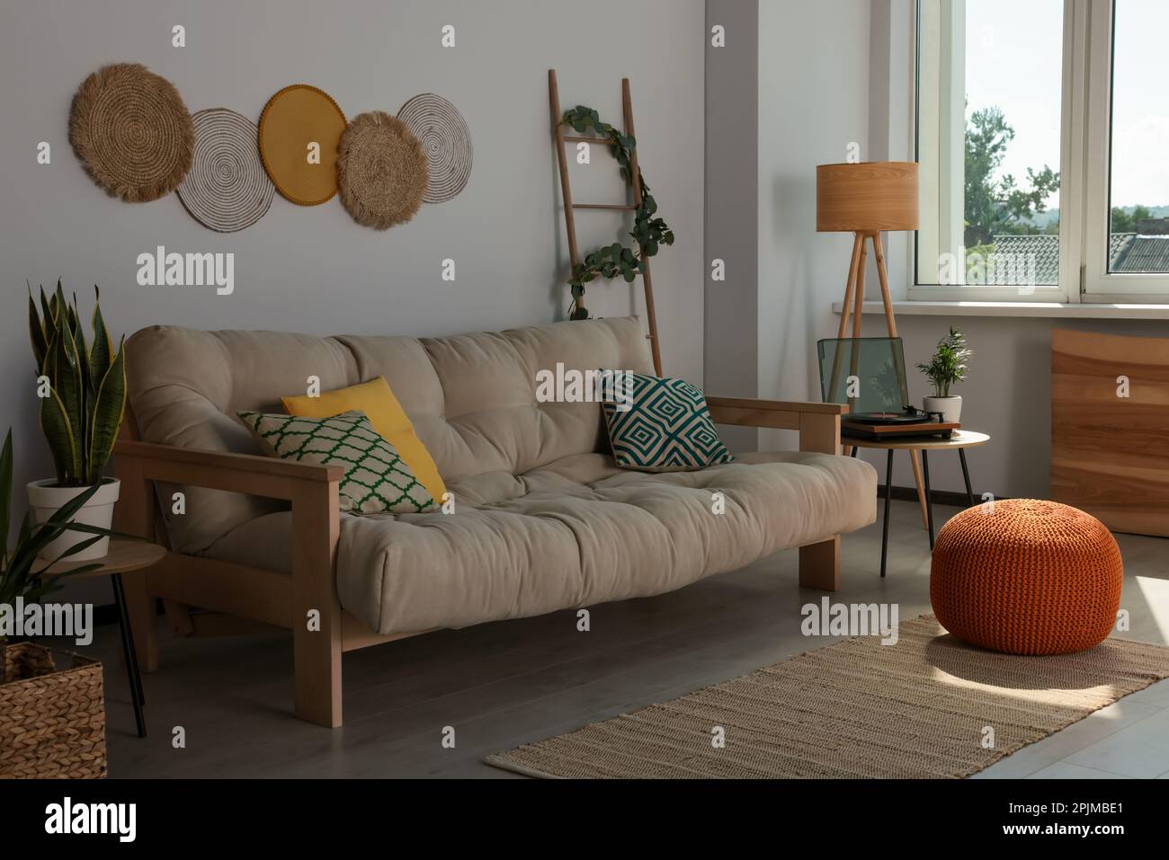 Beautiful living room interior with stylish beige sofa Stock Photo - Alamy