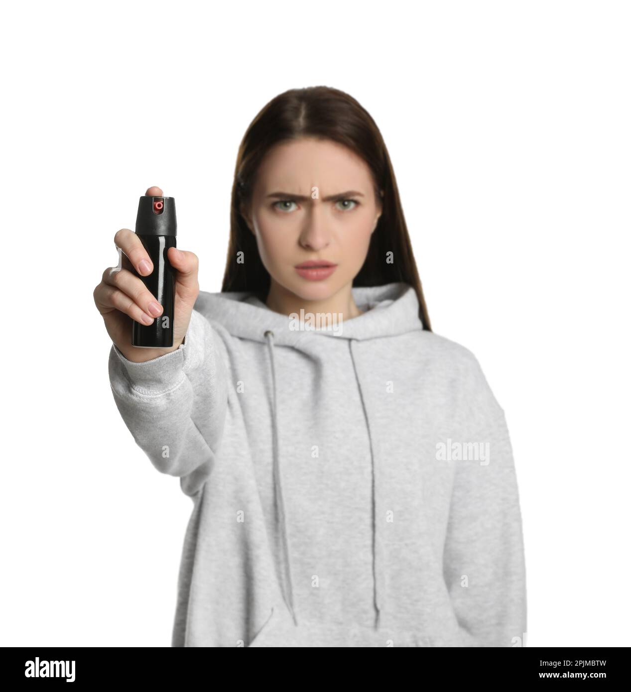 Young woman using pepper spray on white background Stock Photo Alamy