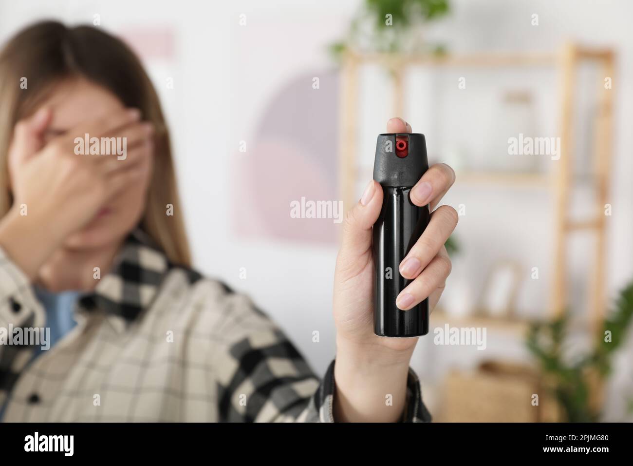 Woman using pepper spray indoors, focus on hand Stock Photo Alamy