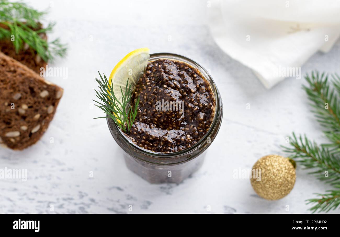 Vegan healthy chia caviar with nori and soy sauce in a jar, bread with