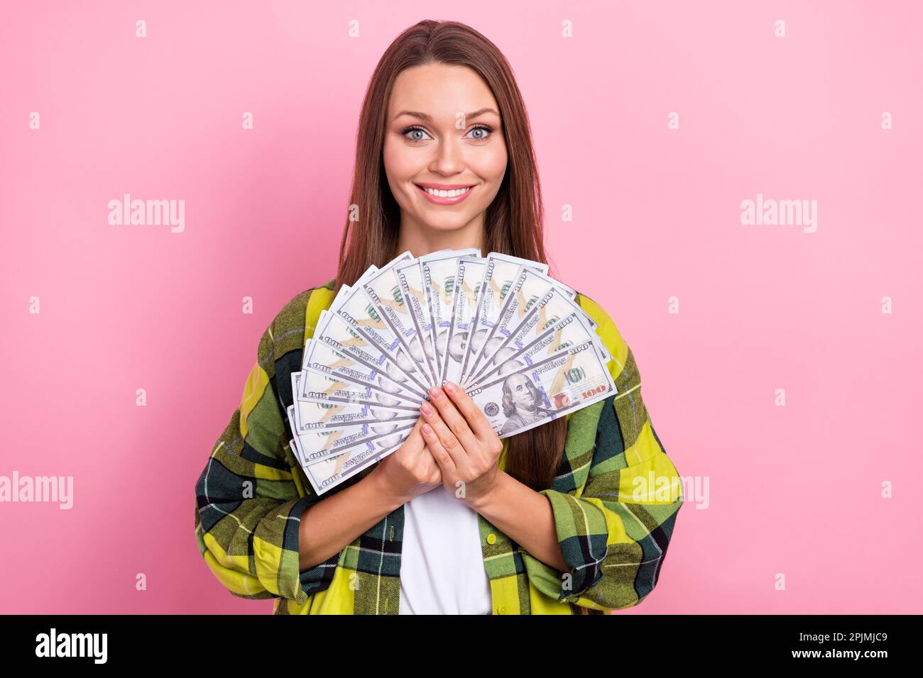Photo of cheerful lovely girl hands hold dollar banknotes bills toothy ...