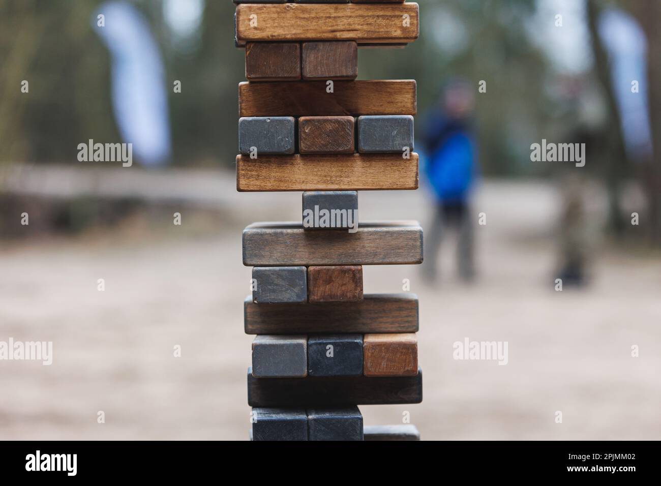 Jenga tower game in nature. Close-up shot of Jenga wooden block game. Concept of risk management. High quality photo Stock Photo