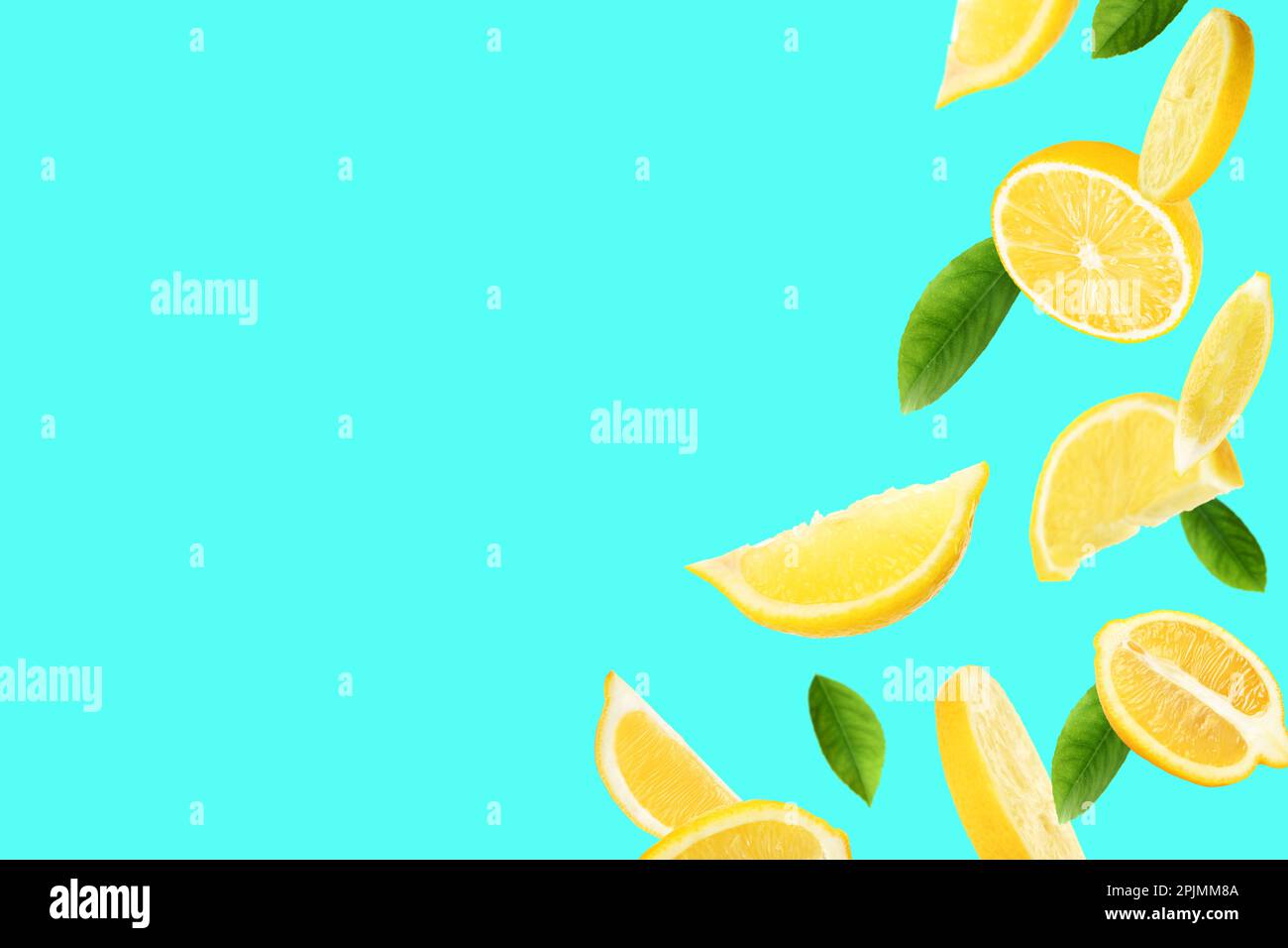 Fresh ripe lemons and green leaves on turquoise background. Space for text Stock Photo