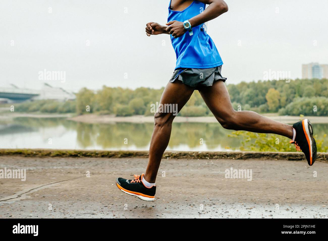 male african runner athlete running marathon race in embankment river