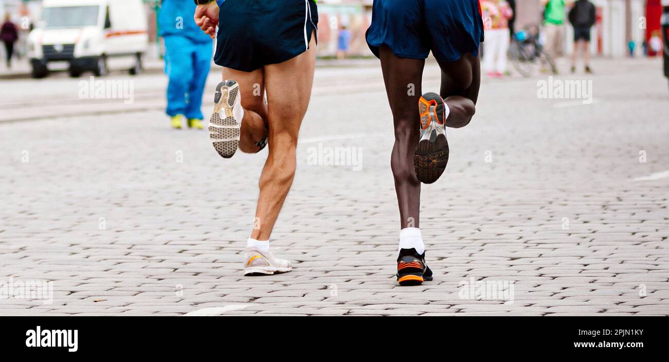 two runners kenyan and european running marathon, jogger run world  championships race, soles running shoes Stock Photo - Alamy