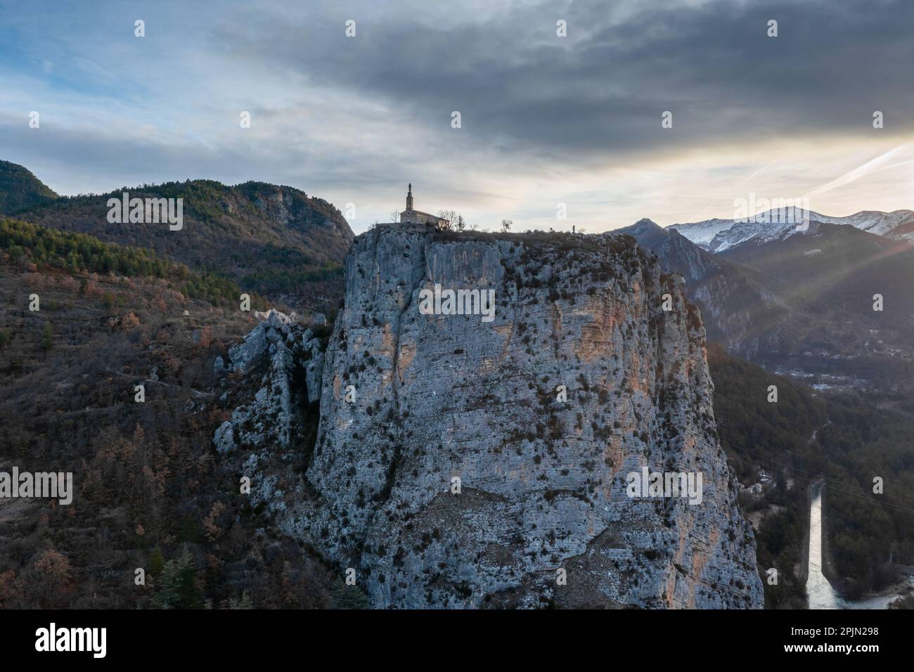 A view of the Notre Dame du Roc Chapel on its clifftop promontory above Castellane village in the upper Verdon Gorge Stock Photo