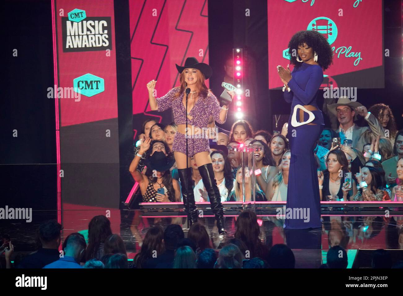 Country singer SHANIA TWAIN (l) accepts her award from presenter and rapper MEGAN THEE STALLION (r) onstage at the 2023 Country Music Awards (CMT) held for the first time in Austin, Texas on April 2, 2023 at the Moody Center before a sold out crowd. Credit: Bob Daemmrich/Alamy Live News Stock Photo