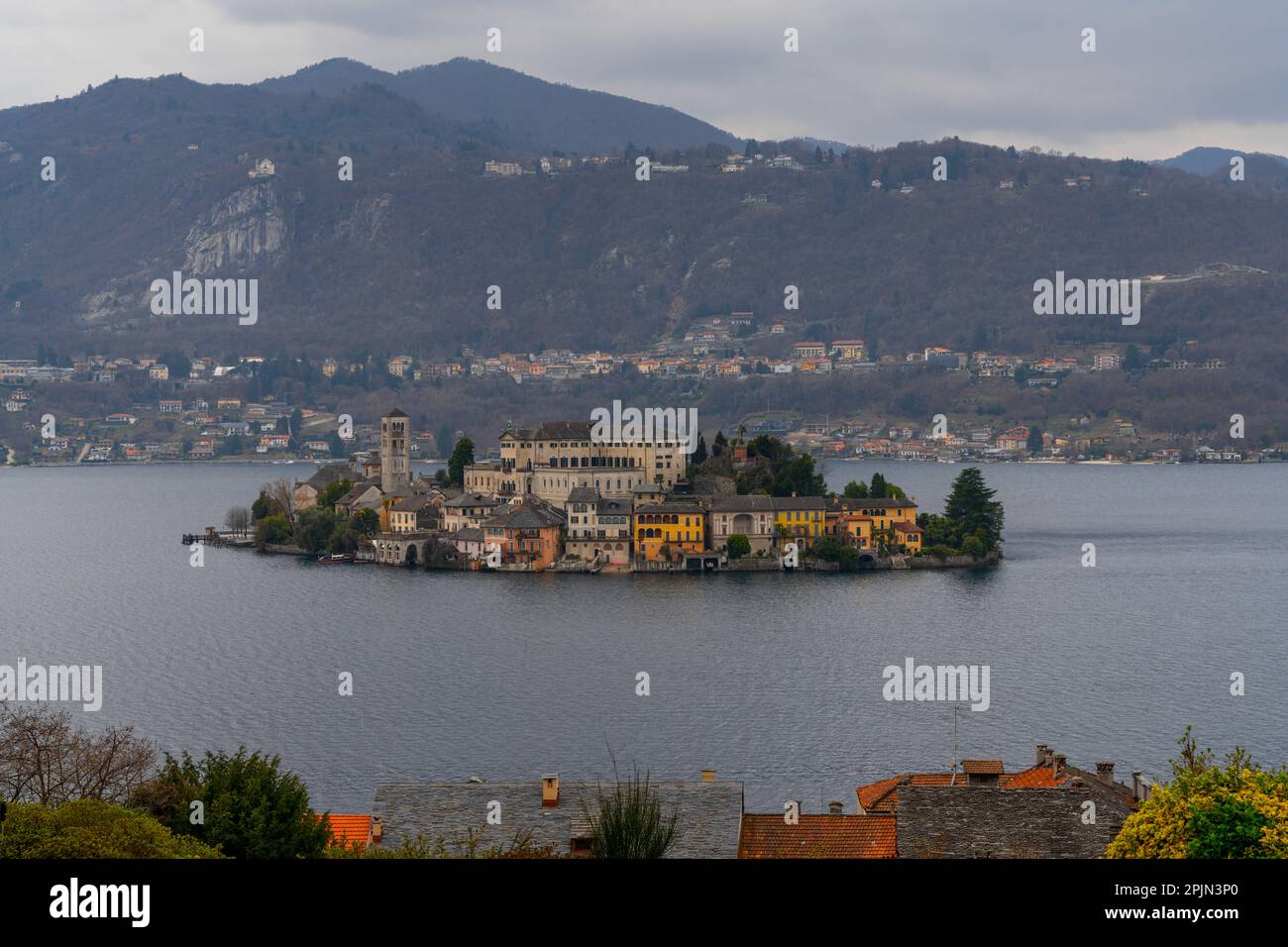 Orta San Giulio, Italy - 13 March, 2023: view of Lake Orta and the Isola San Guilio islet with its historic buildings Stock Photo