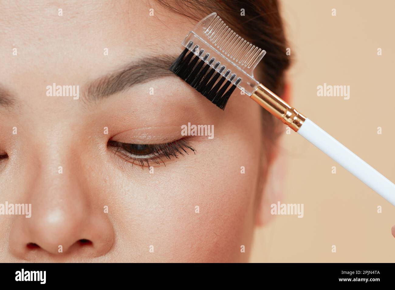 Closeup on asian woman with brow brush. Stock Photo