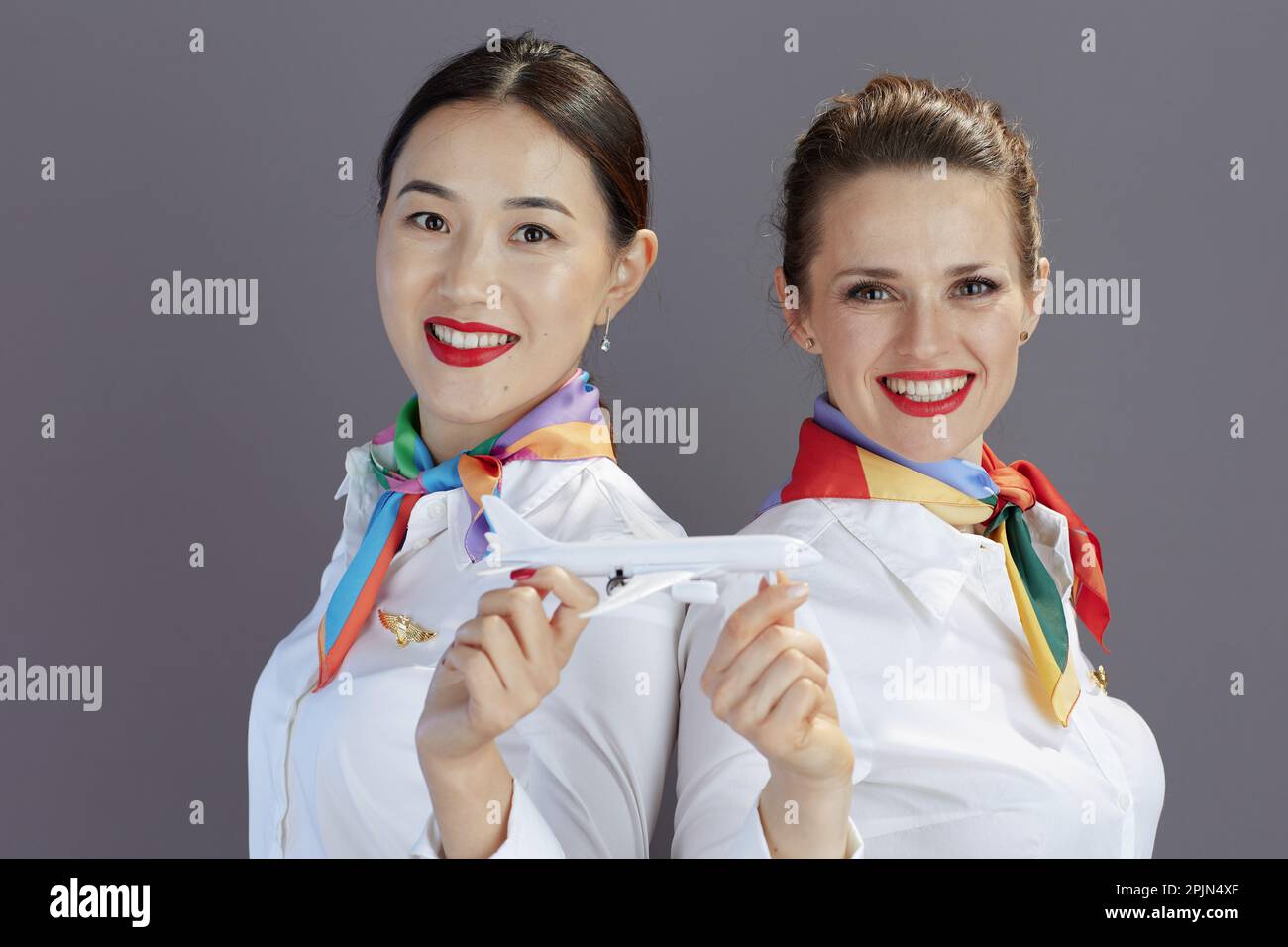 portrait-of-smiling-elegant-flight-attendant-women-in-blue-skirt-white