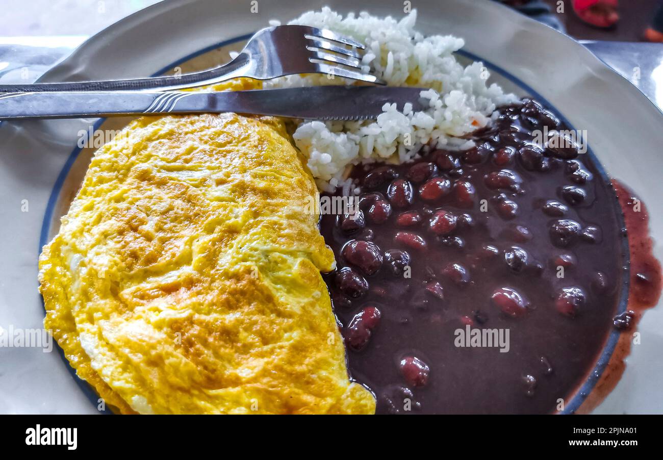 Mexican omelet and scrambled eggs with black beans rice and nachos on