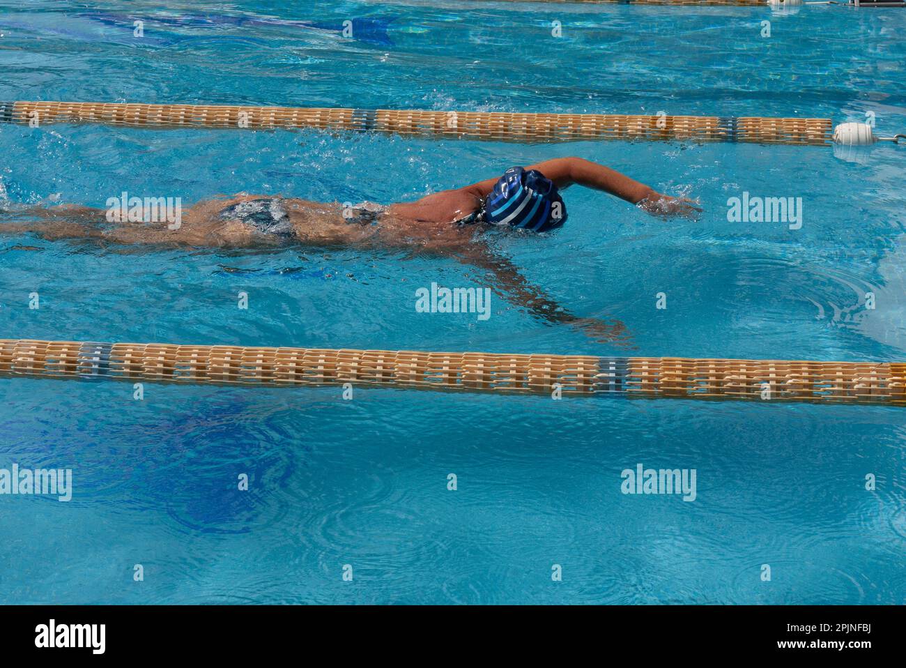 a woman in a bikini swims in the pool Stock Photo