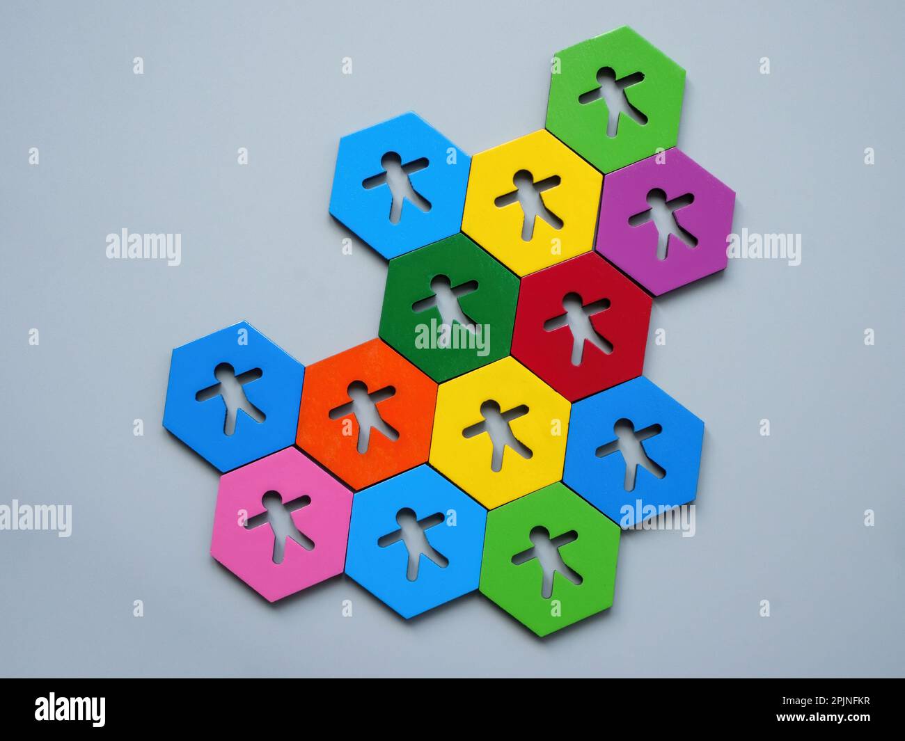 Multi-colored hexagons with figures as a symbol of unity and teambuilding. Stock Photo