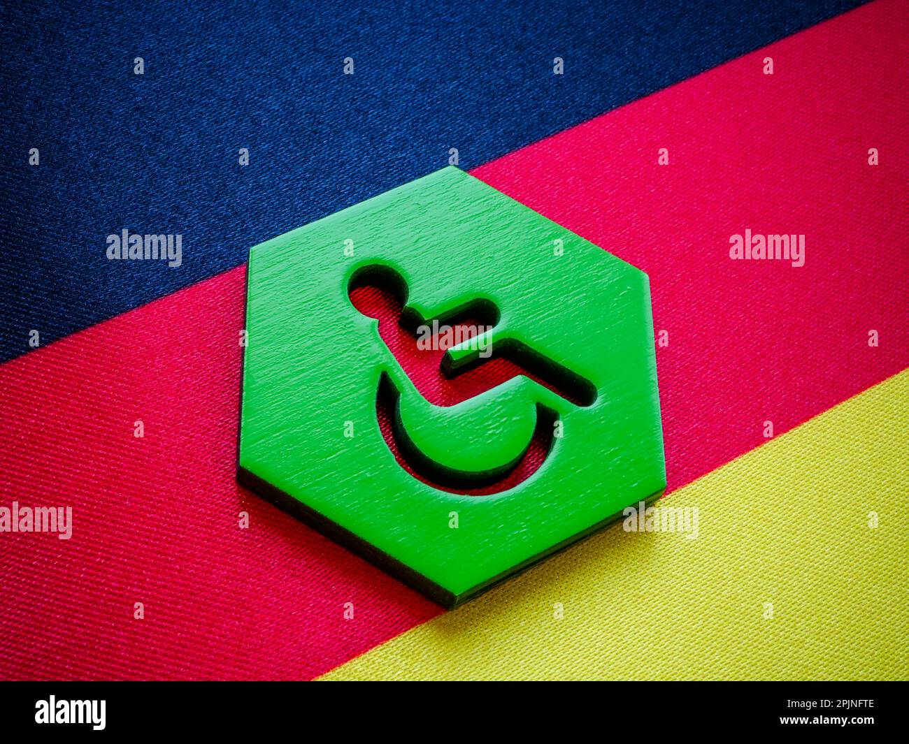 Hexagon with disabled person allowance sign and German flag Stock Photo