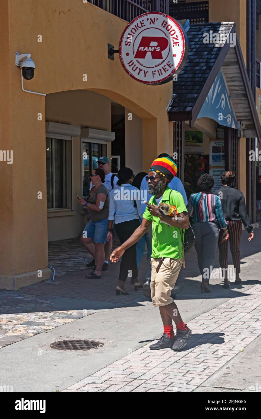 Man with a monkey on the street, Saint Kitts, West Indies Stock Photo