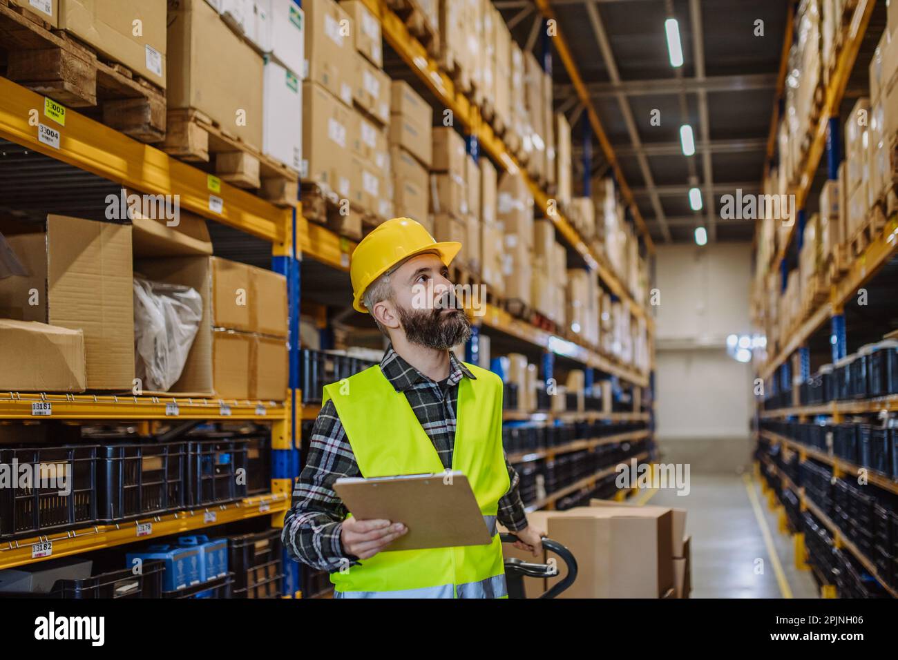 Warehouse worker stocking goods in a warehouse Stock Photo Alamy