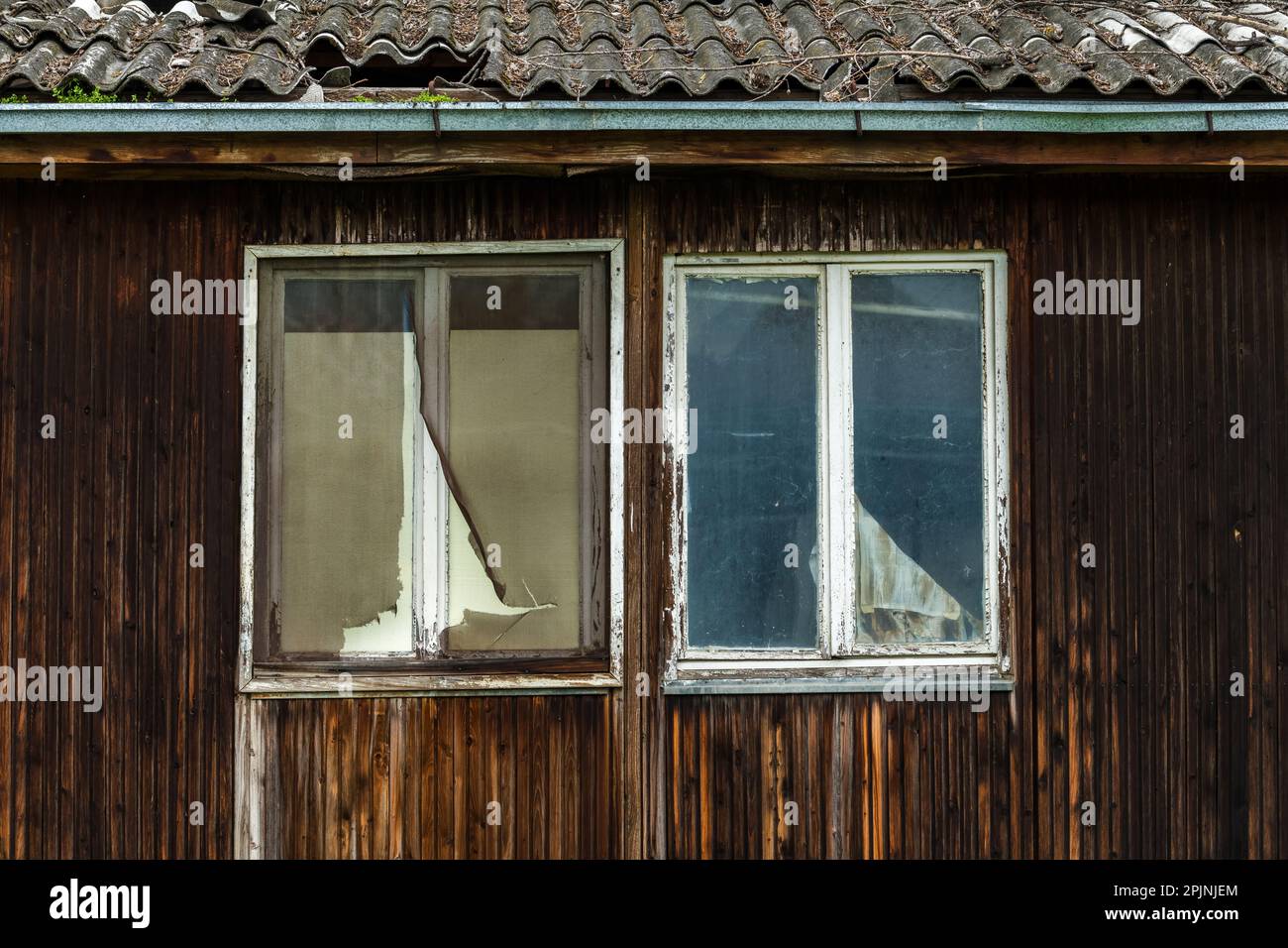 Old worn ruined wooden prefabricated house ready to be run down Stock Photo