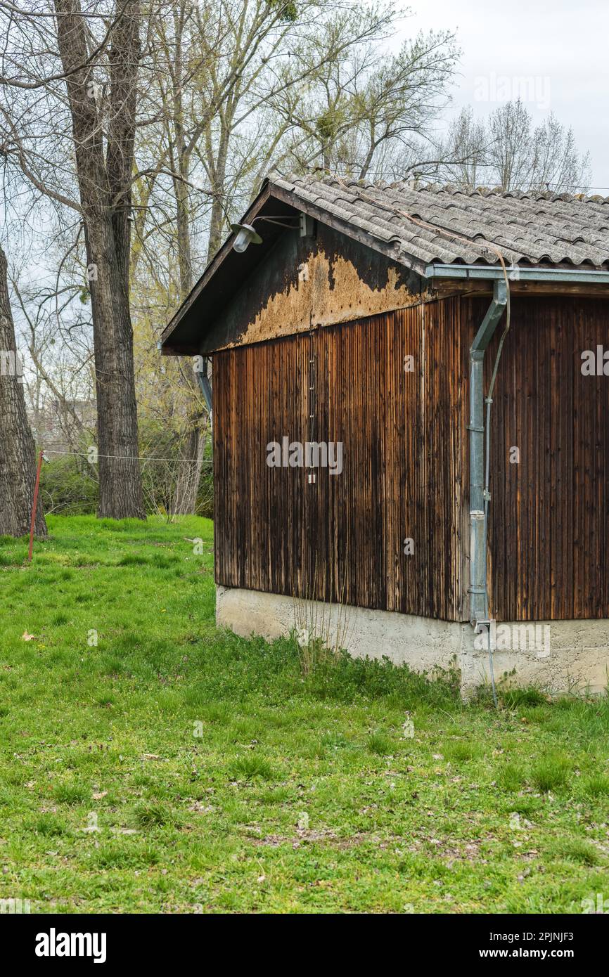 Old worn ruined wooden prefabricated house ready to be run down Stock Photo