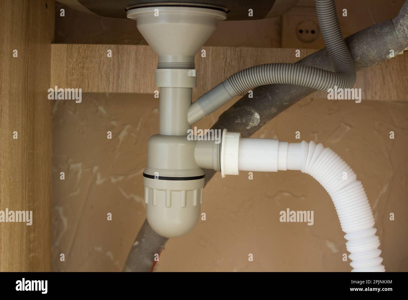 Siphon pipes under the kitchen sink in the kitchen Stock Photo