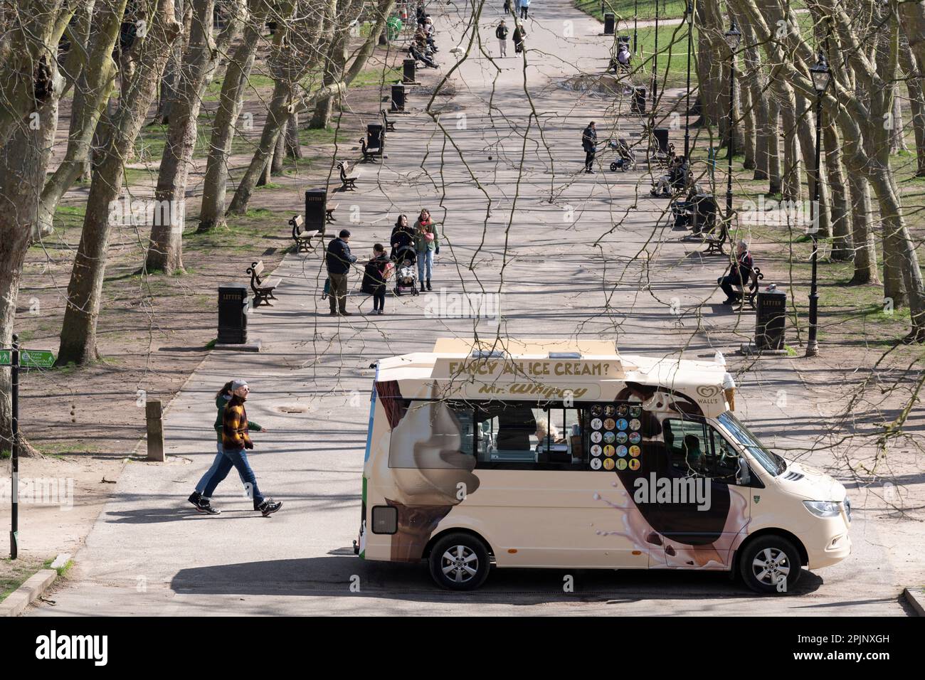 A Mr Whippy ice cream van sells to half-term visitors on a tree-lined avenue in Crystal Palace Park, on 3rd April 2023, in London, England. Stock Photo