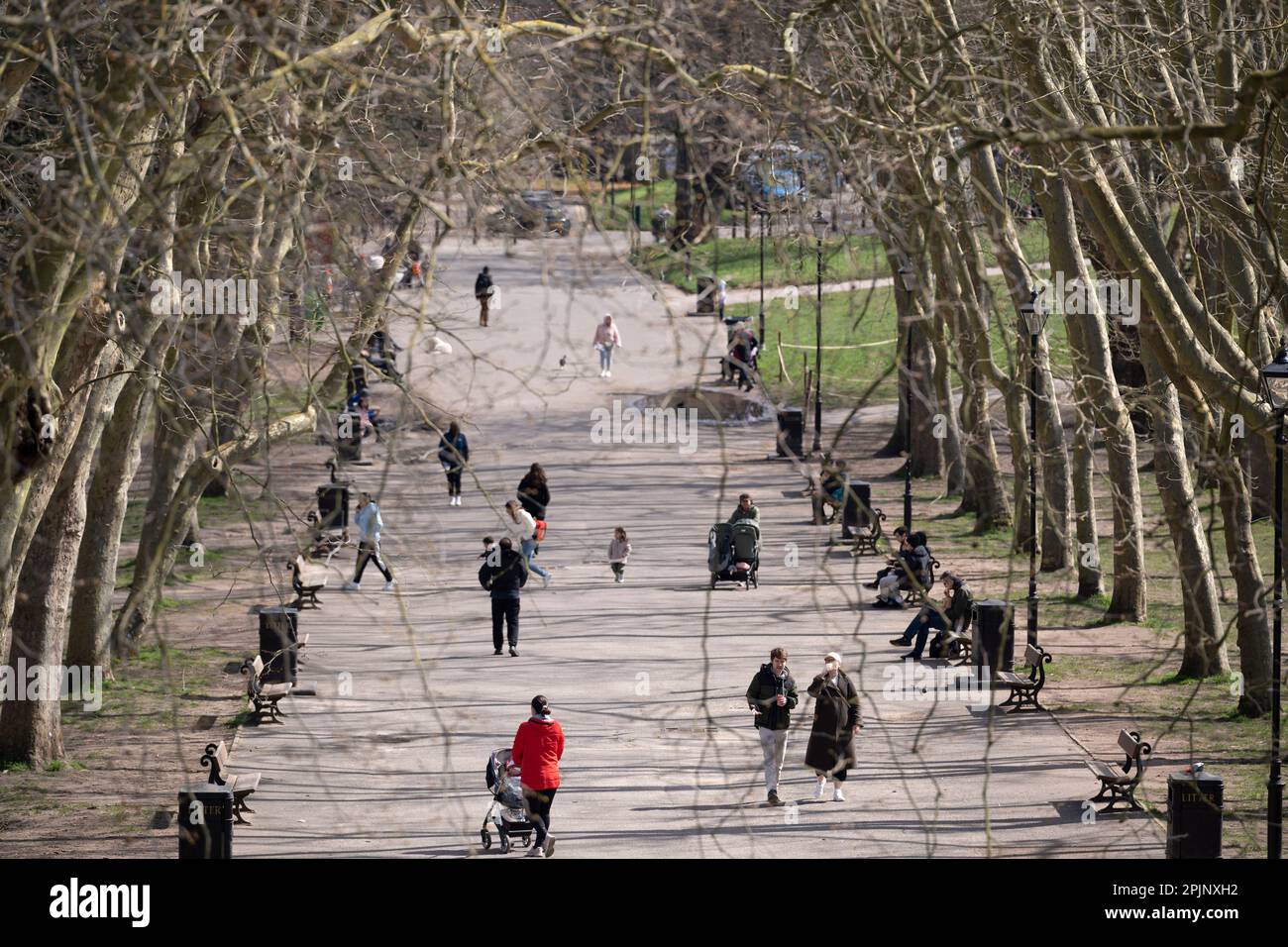 Half-term visitors enjoy a tree-lined avenue in Crystal Palace Park, on 3rd April 2023, in London, England. Stock Photo
