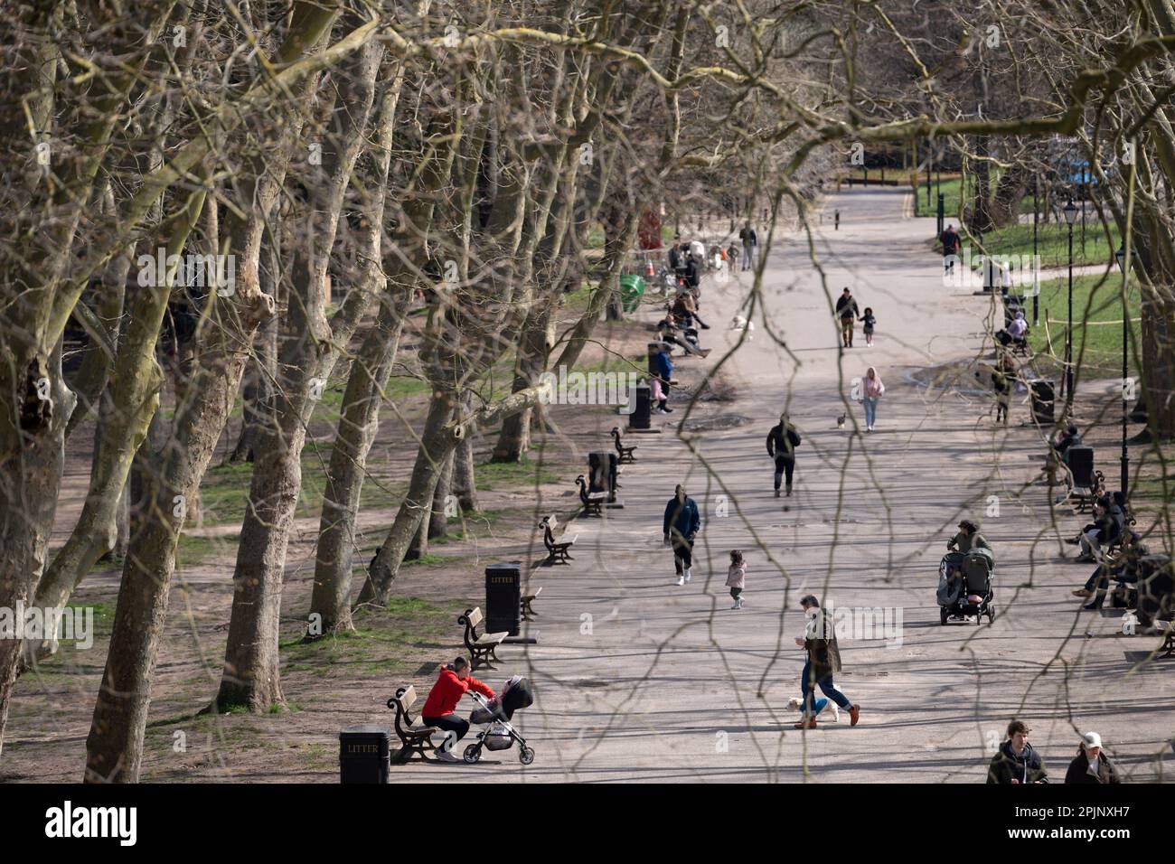 Half-term visitors enjoy a tree-lined avenue in Crystal Palace Park, on 3rd April 2023, in London, England. Stock Photo