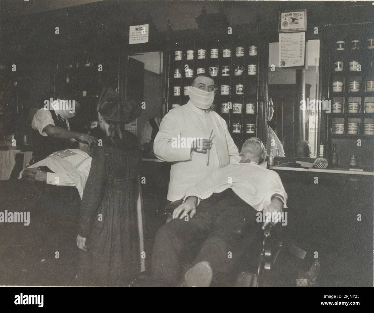 Cincinnati barbers wear masks to prevent the spread of the Spanish flu