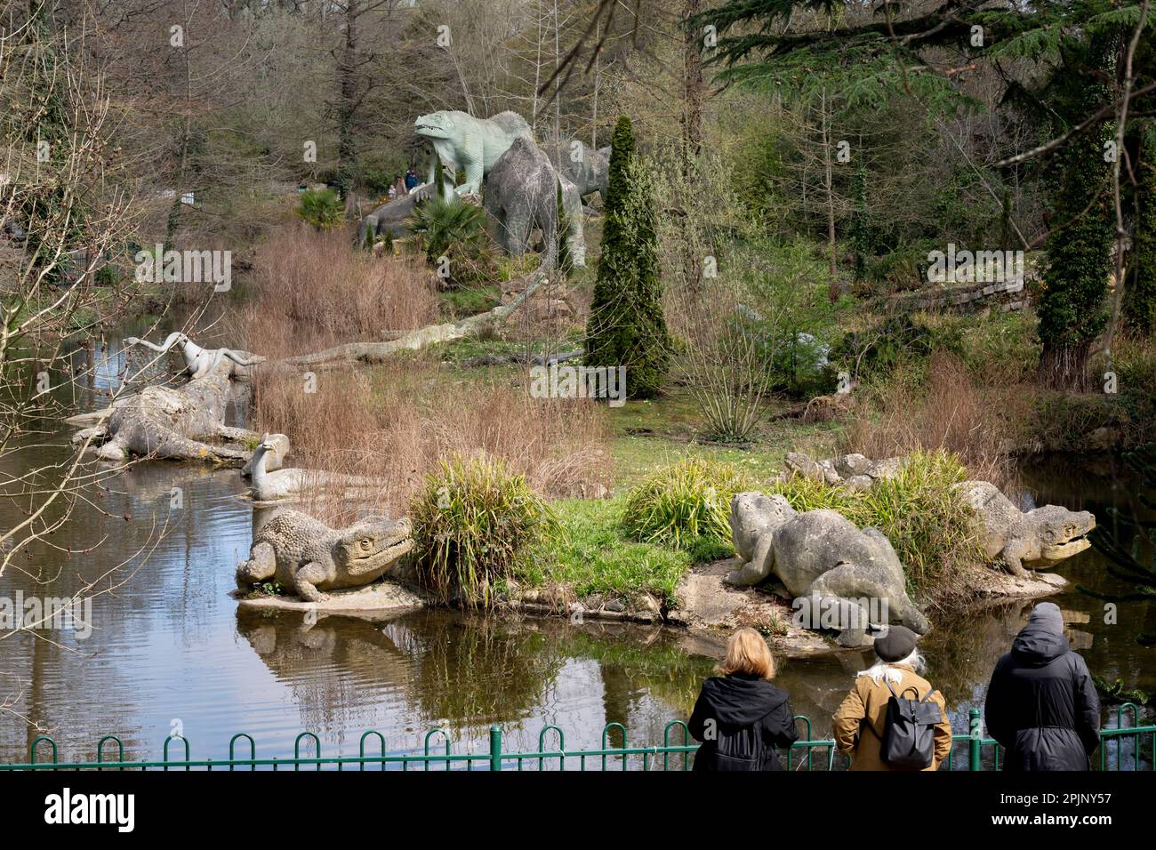 A park landscape of victorian era grade i listed dinosaur sculptures in