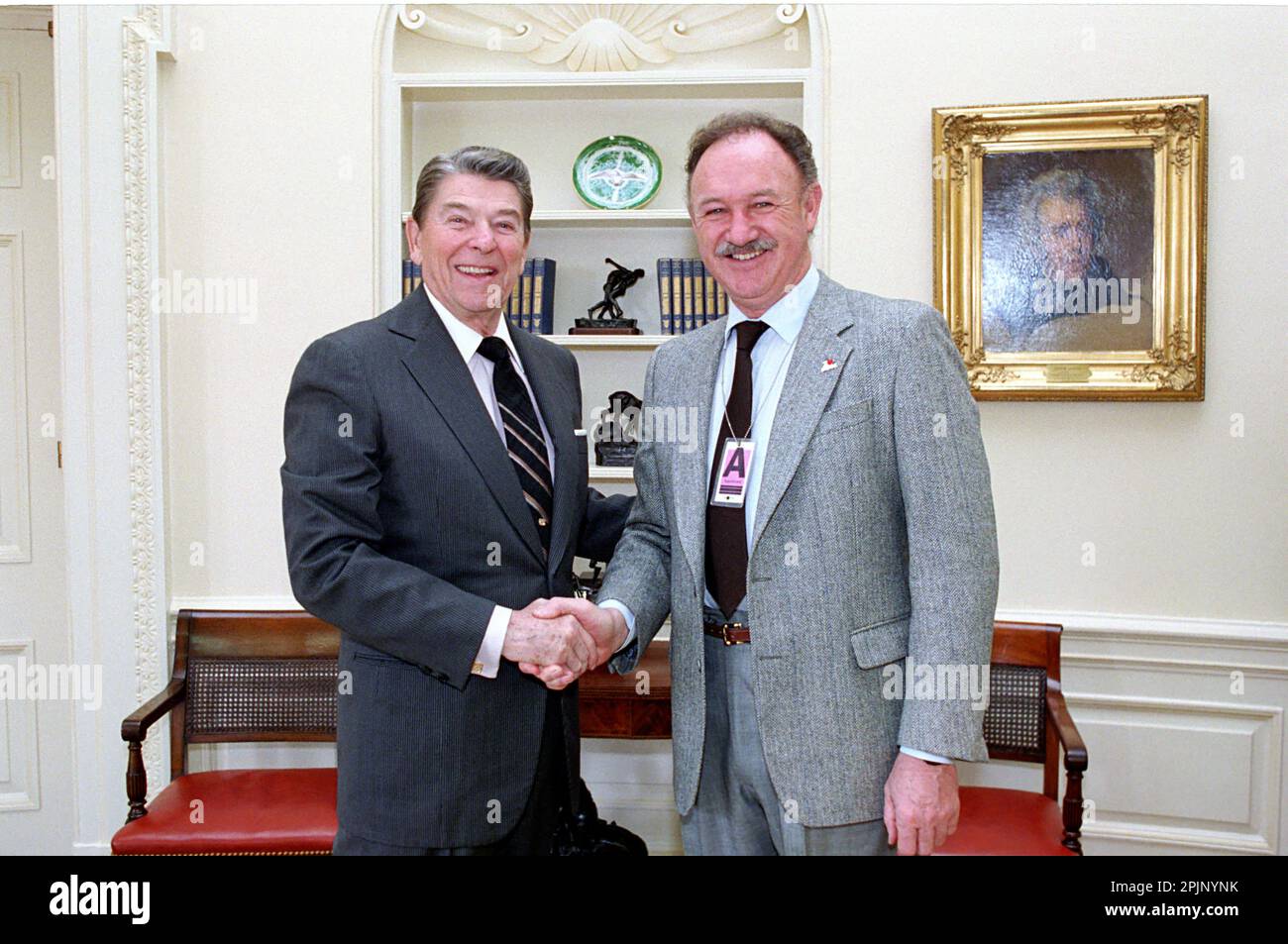 President Ronald Reagan greets actor Gene Hackman (right) in the White House Oval Office, Washington, DC,2/6/1987. (Photo by White House Photo Collection) Stock Photo