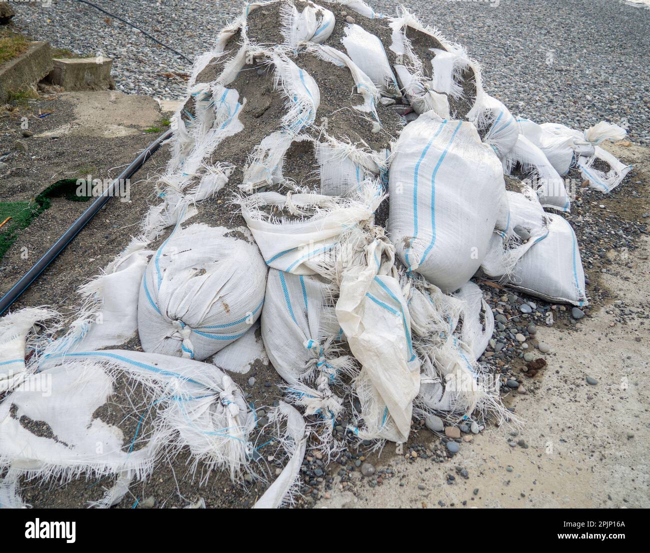Old bags of cement. White bags with building material. Stopped repair