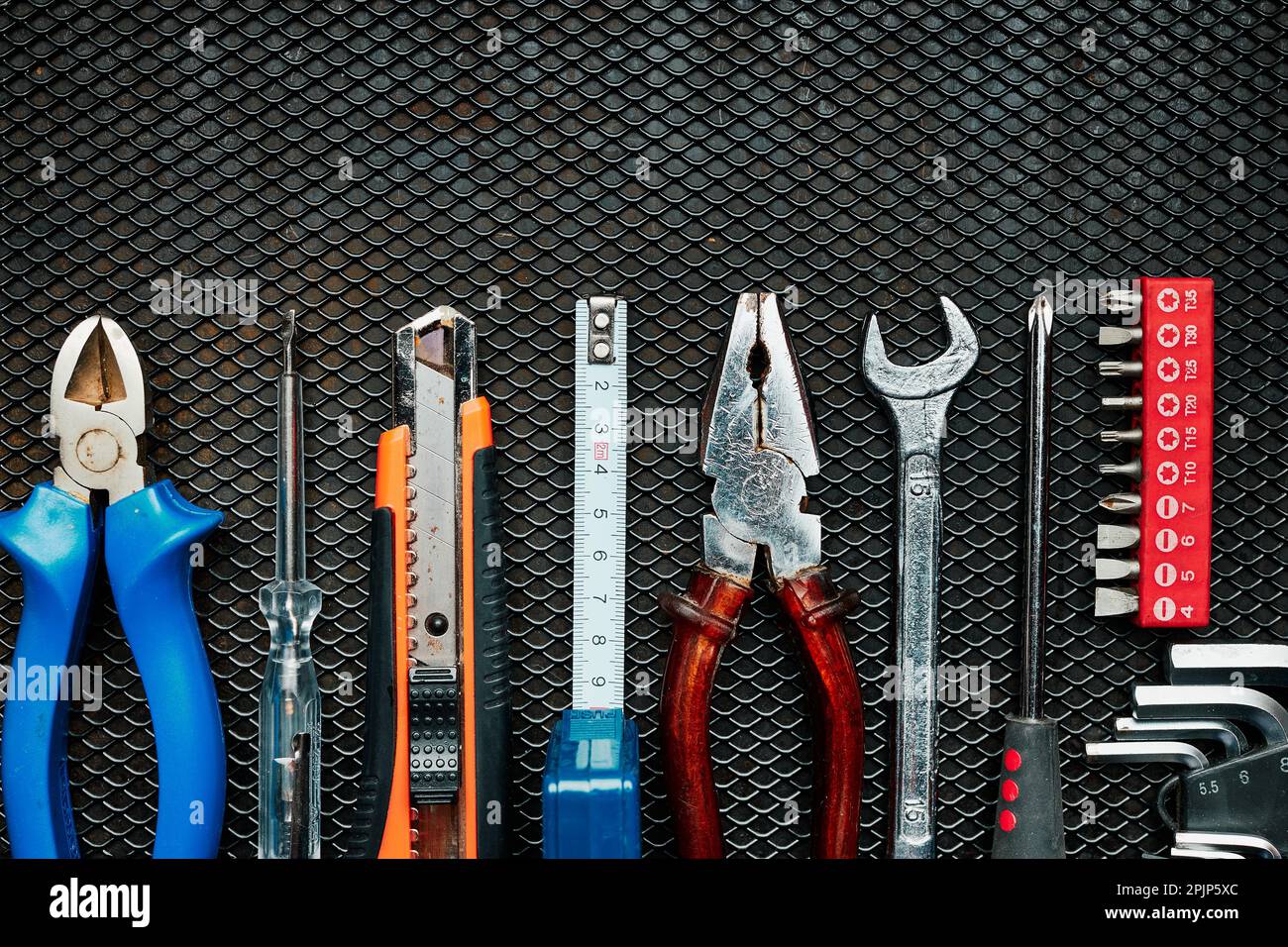 Set of screwdrivers and wrenches hanging on wall with assorted auto  mechanic tools in garage Stock Photo - Alamy