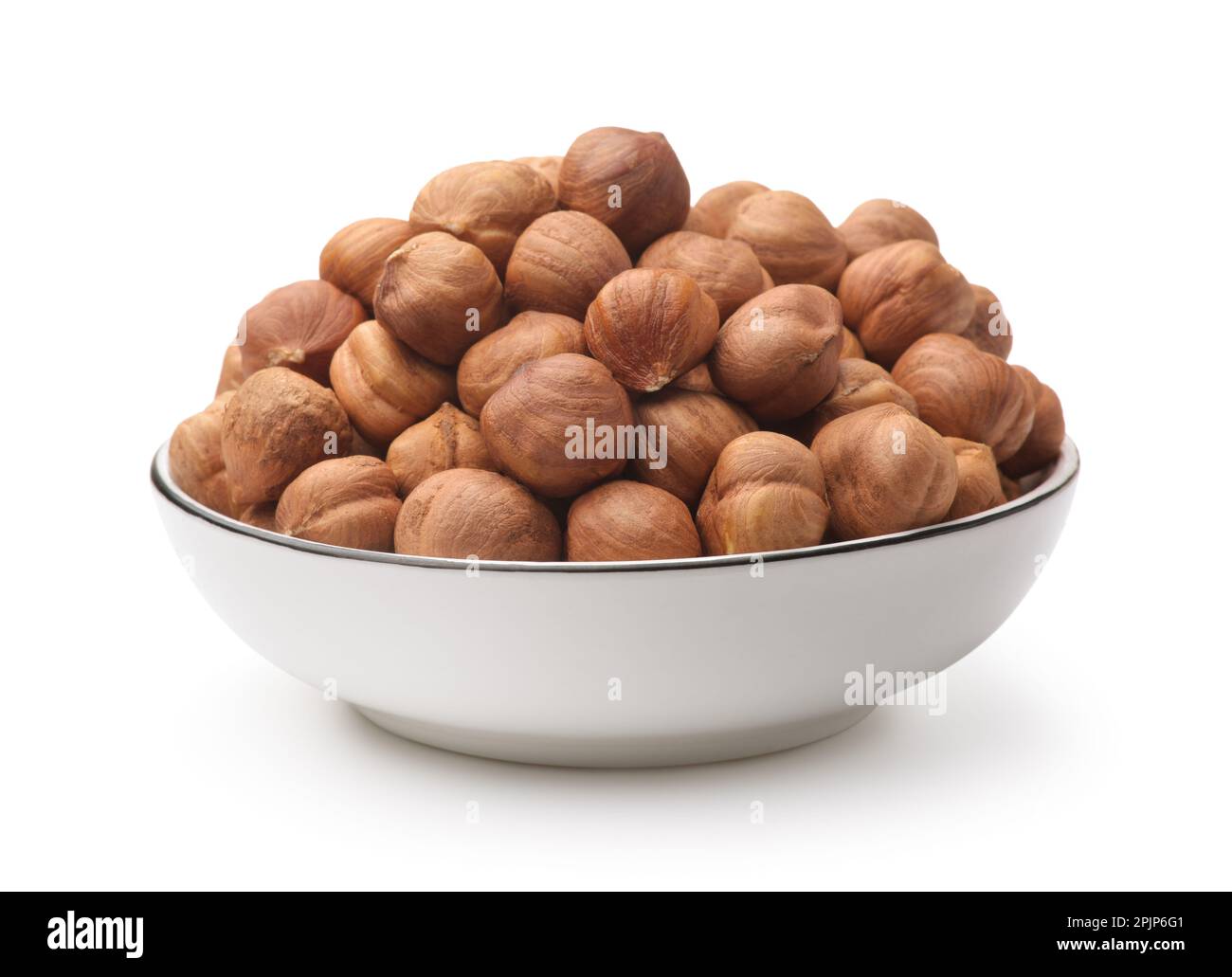 Shelled hazelnut kernels in ceramic bowl isolated on white Stock Photo