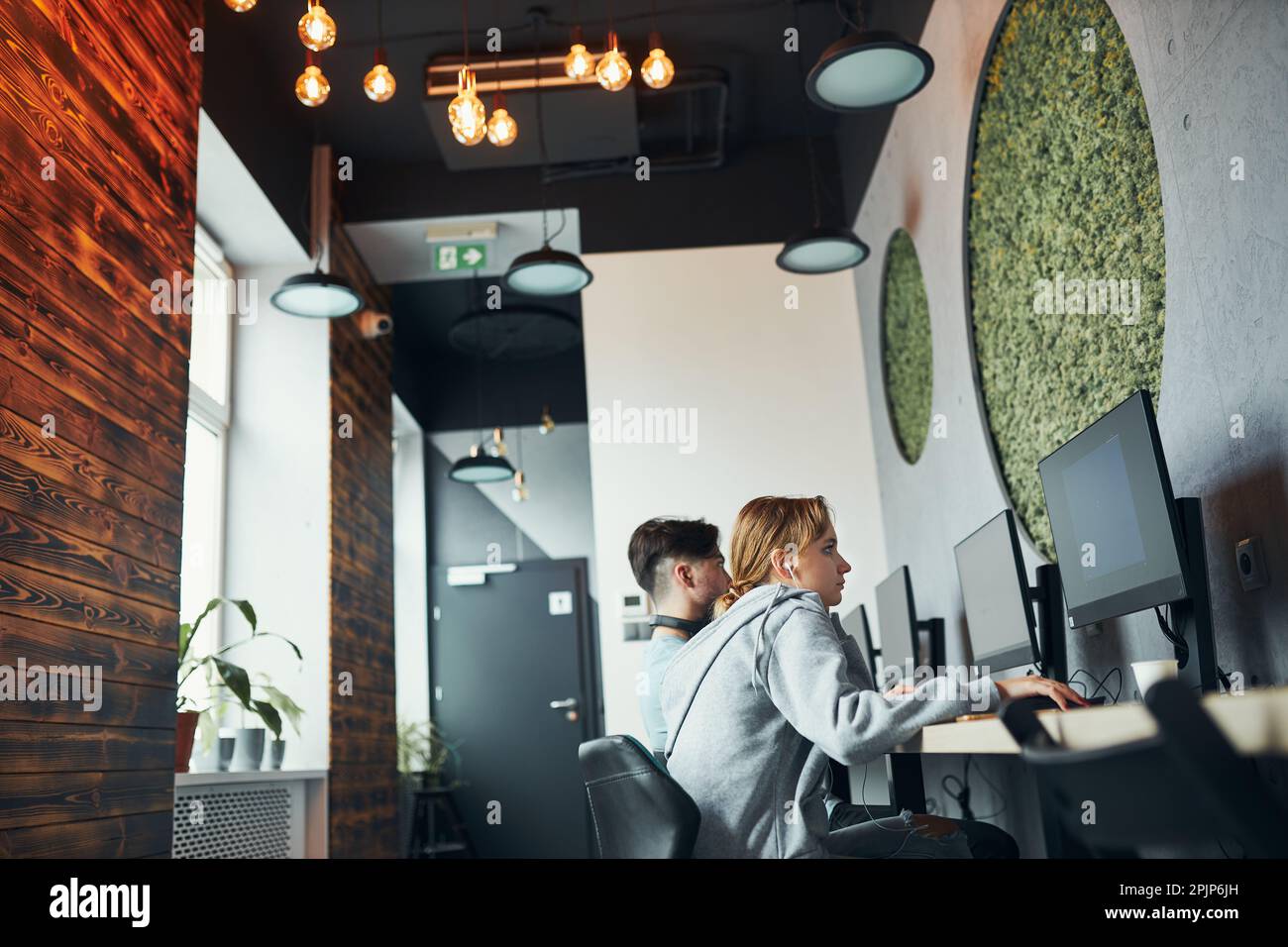 Students learning in computer classroom. Young man preparing for test ...
