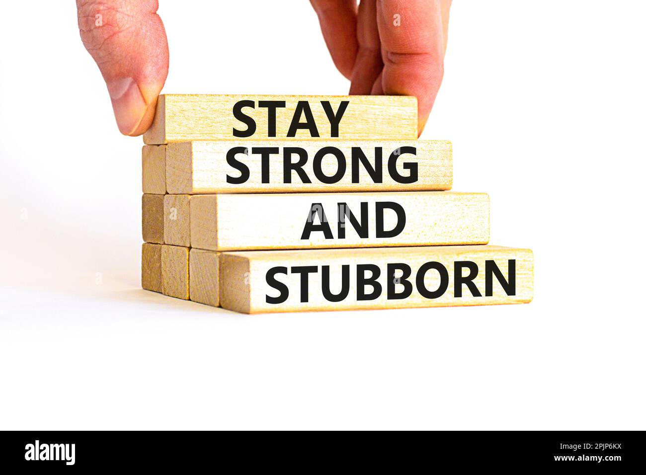Stay strong and stubborn symbol. Concept words Stay strong and stubborn on wooden block