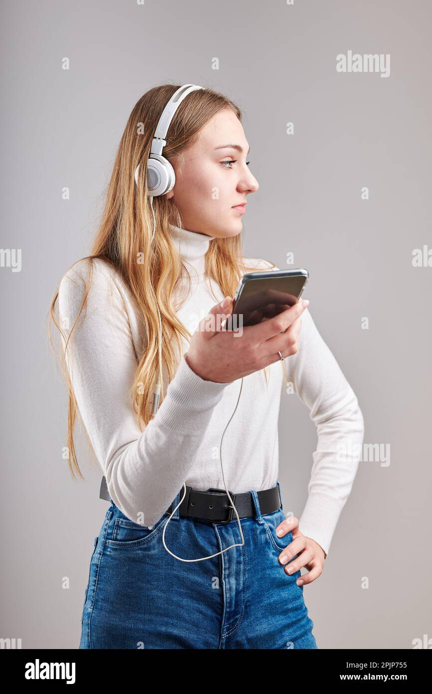 Young woman girl listening to music streaming content having fun ...