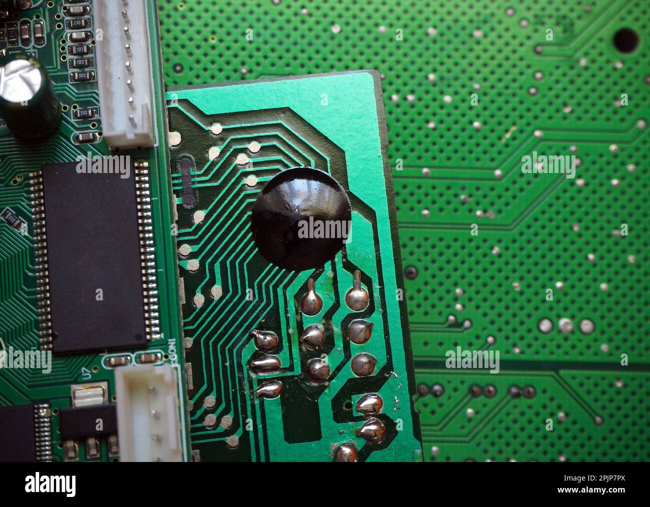 Glob-top technology used in low-end devices. COB, Chip On Board electronic packaging. Circuit board manufacturing background. Stock Photo