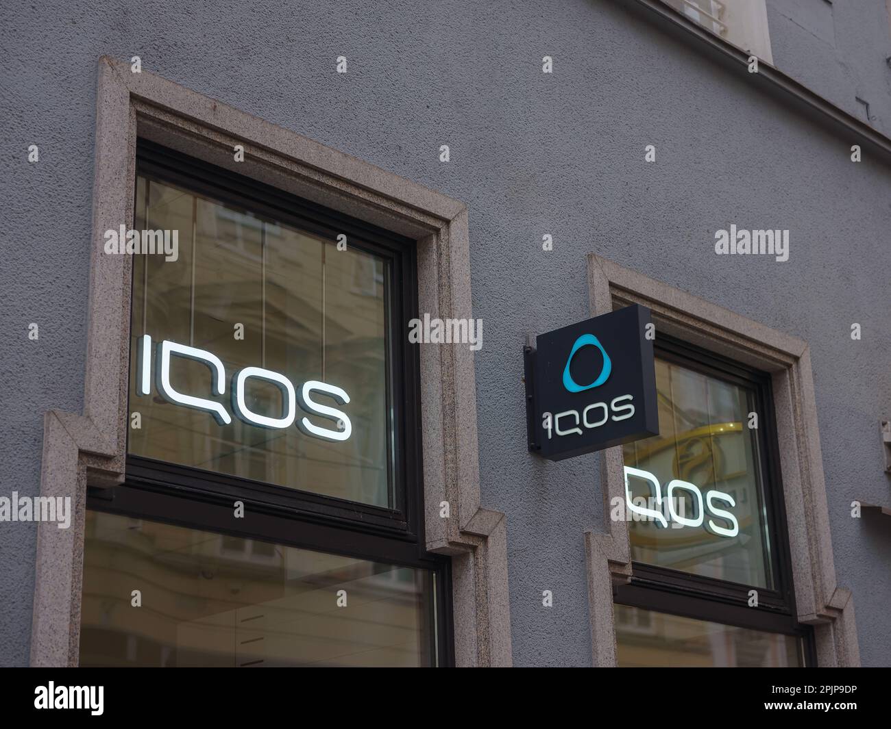 Linz, Austria - August 6, 2022: Facades IQOS store in city. IQOS advertisement. Heating tobacco system iqos tobacco product technologies beloning to P Stock Photo