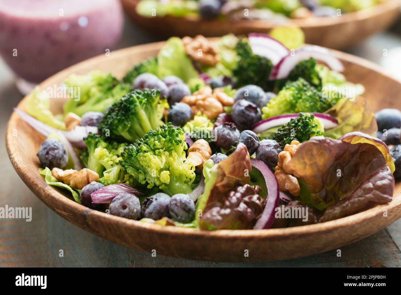 Home made vegan broccoli and blueberry salad with toasted walnuts, served with a blueberry dressing Stock Photo