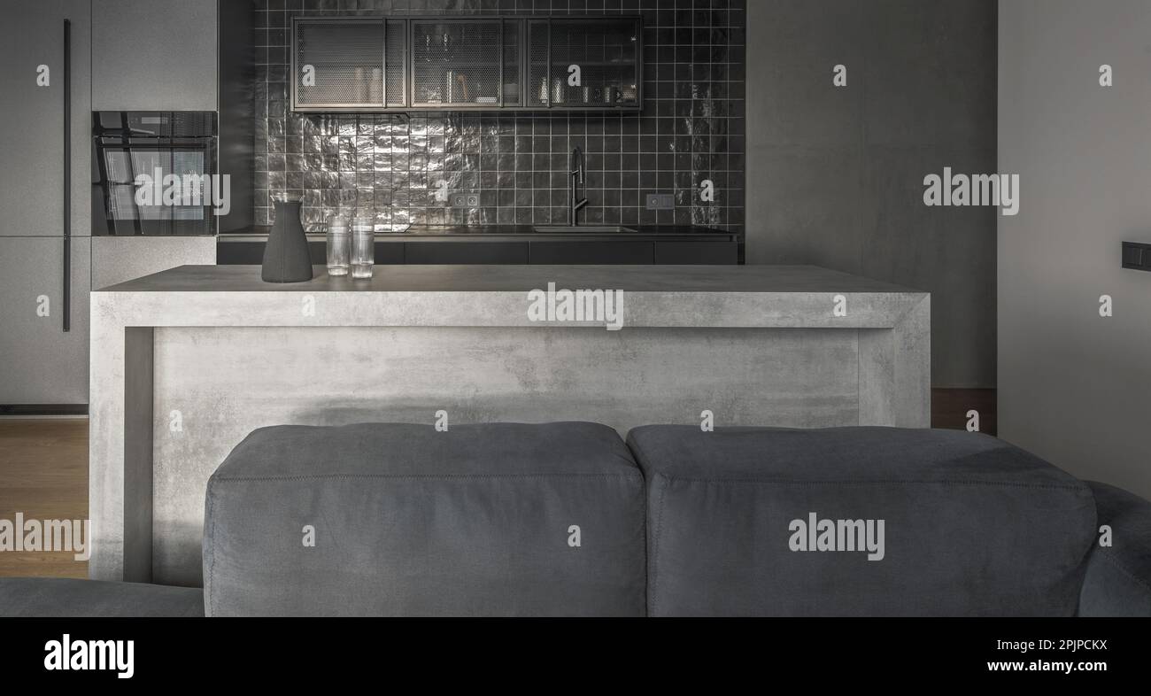 View of Small kitchen interior in grey and black colours, concrete wall design ...