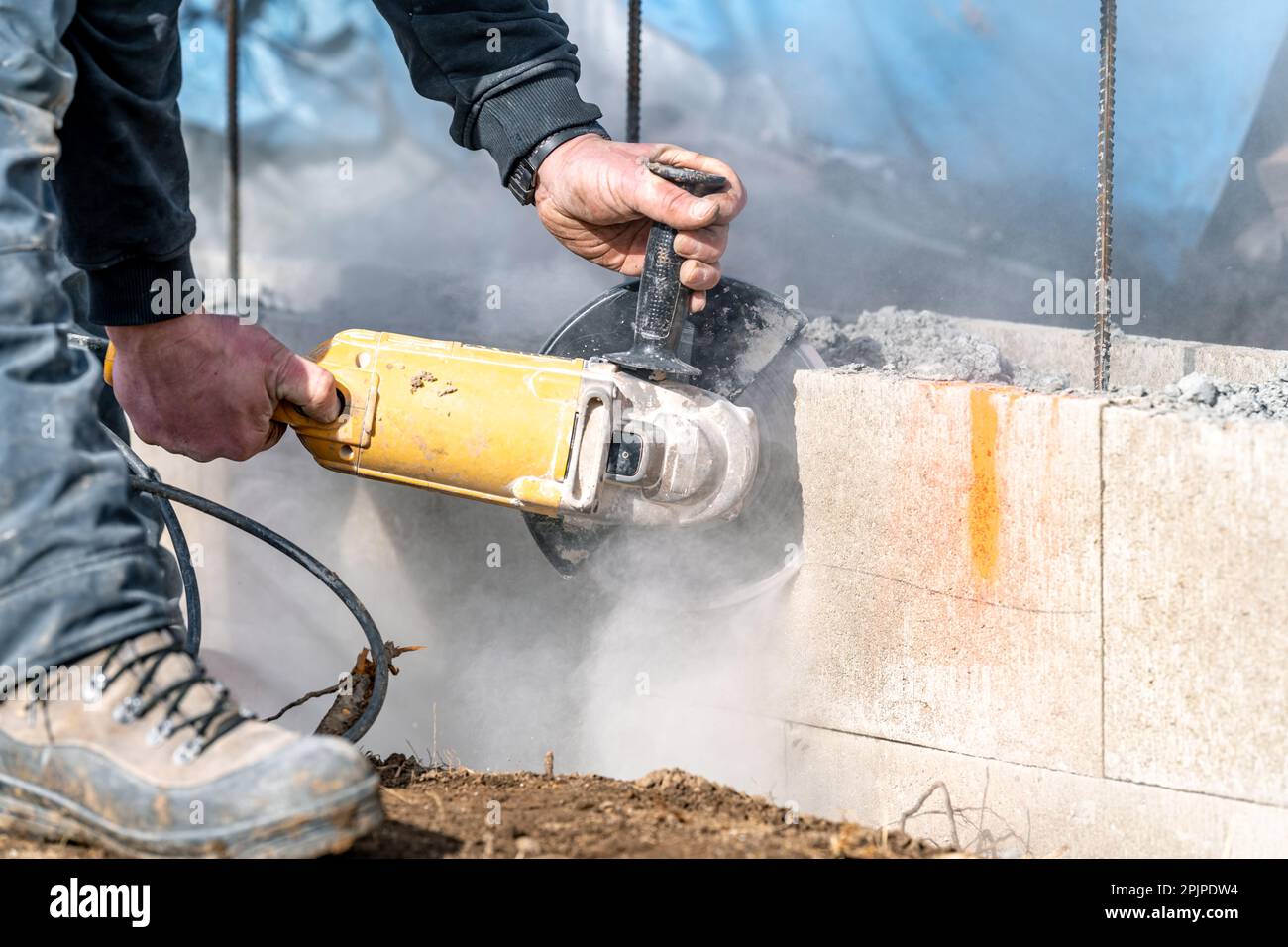 cutting concrete bricks with an electric grinder Stock Photo Alamy