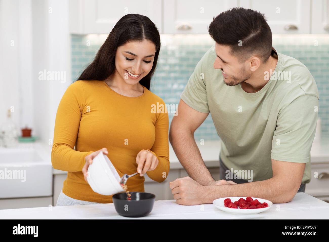 Beautiful middle eastern couple preparing breakfast together Stock Photo