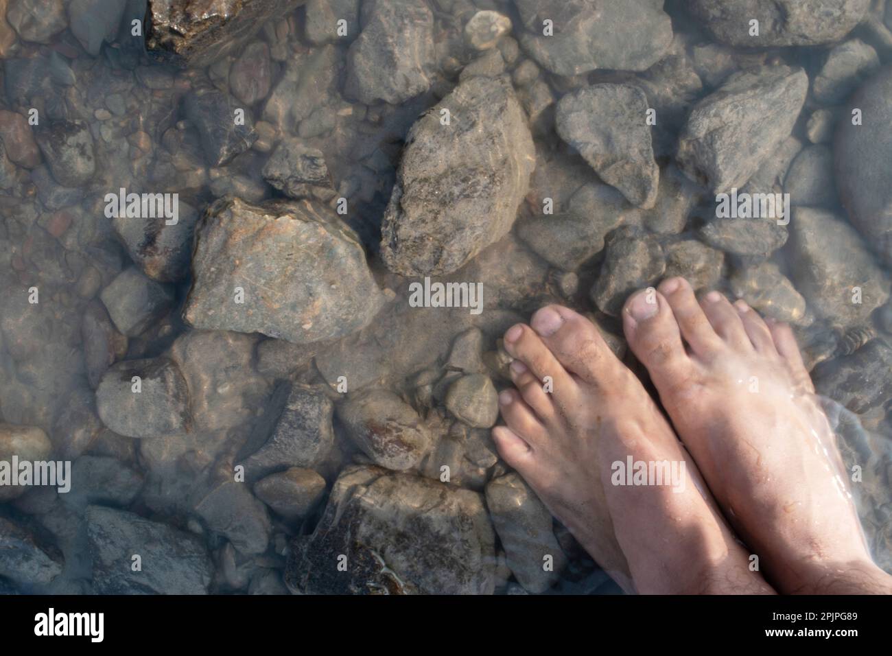 Top view of foot in water and stone, relax feeling Stock Photo Alamy