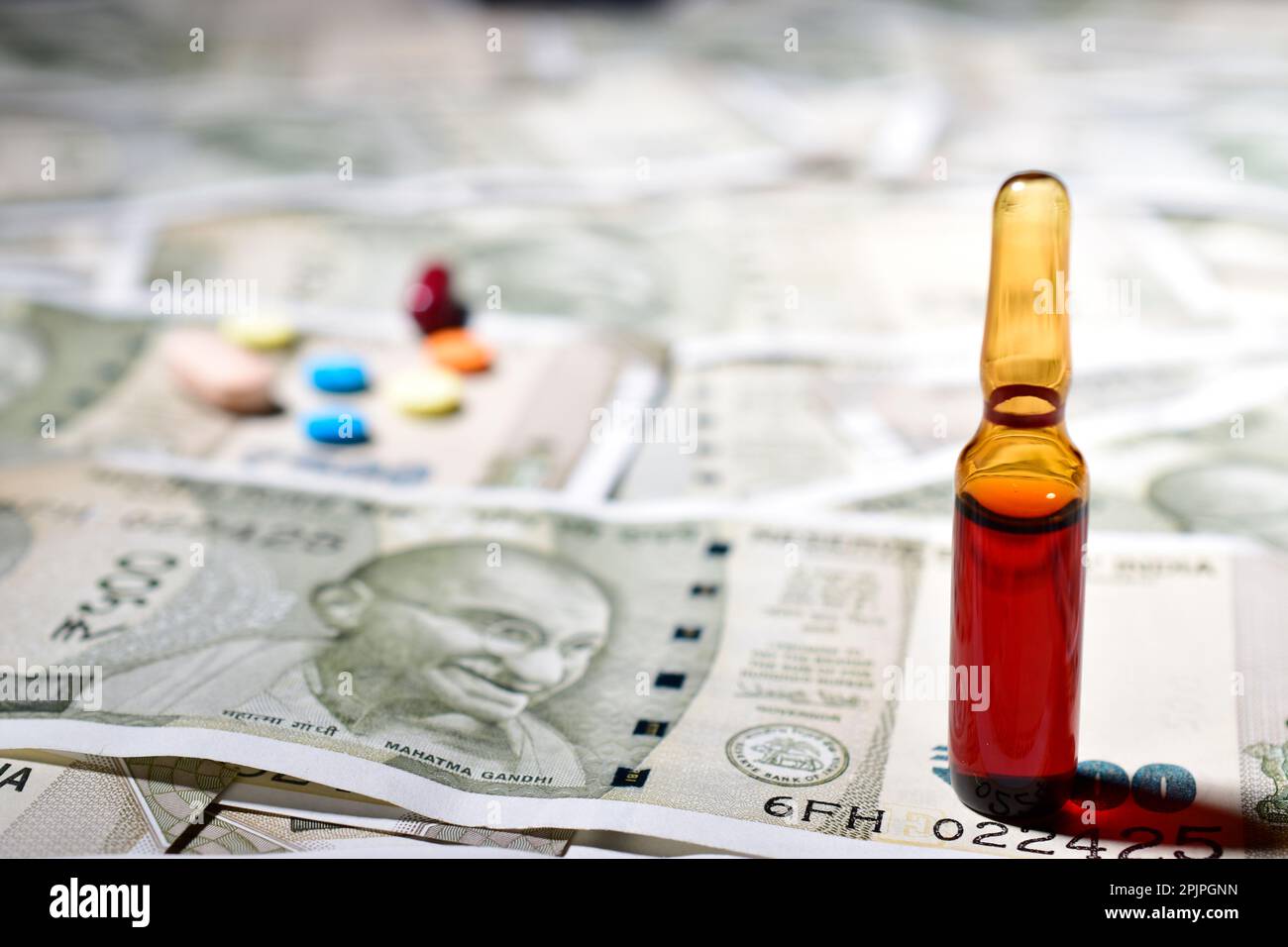 Vial with indian currency note Stock Photo Alamy