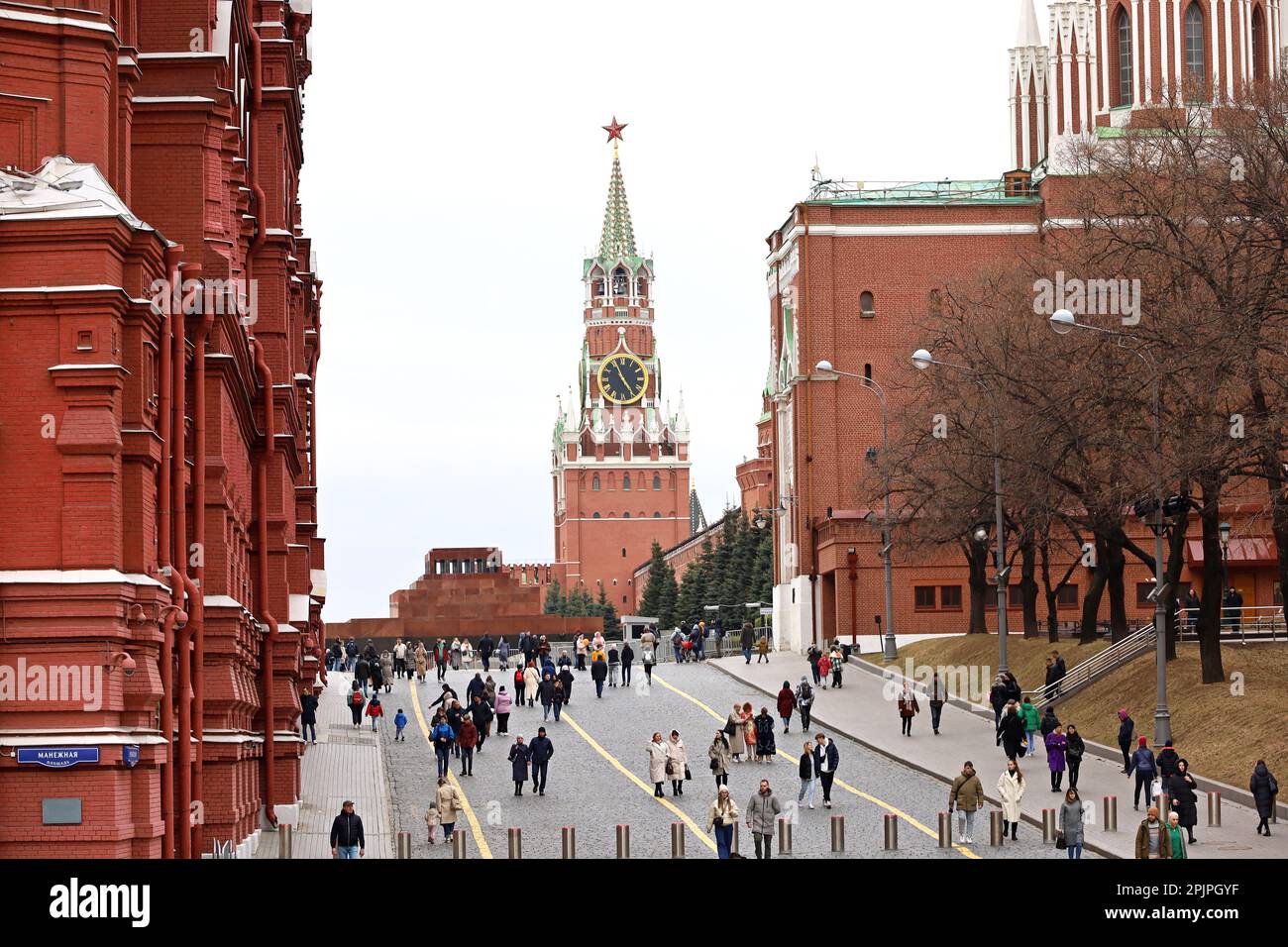 View to Crowd of people walking on Red square on background of Kremlin tower, State historical museum and Lenin mausoleum Stock Photo