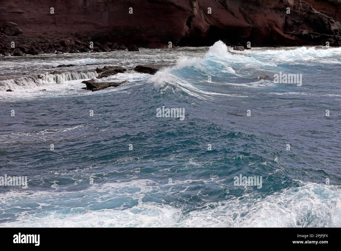 Las Coloadas red cliffs and waves. . February 2023. cym Stock Photo